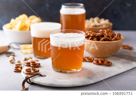 Traditional lager beer in variety of glasses with snacks on the table 106891751