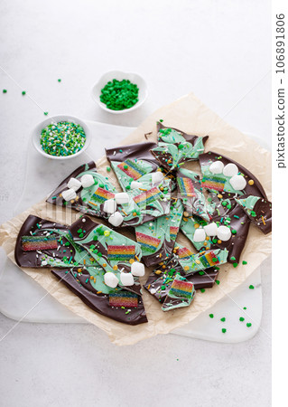 St Patricks day chocolate bark with sprinkles and rainbows 106891806