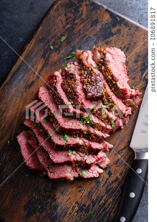 Corned beef cooked and sliced on a cutting board 106891817