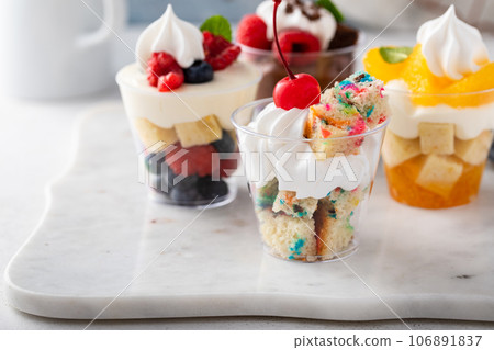 Variety of small desserts in cups, chocolate, berry and orange Variety of small desserts in cups, chocolate, berry and orange 106891837