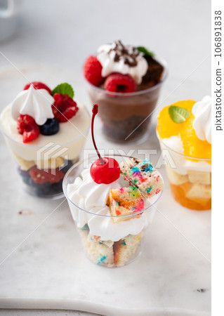 Variety of small desserts in cups, chocolate, berry and orange Variety of small desserts in cups, chocolate, berry and orange 106891838