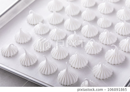 Meringue kisses on a baking sheet ready to be baked Meringue kisses on a baking sheet ready to be baked 106891865