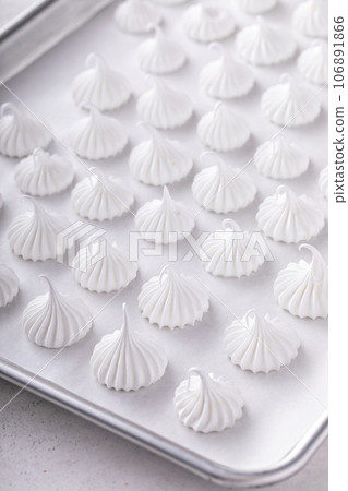 Meringue kisses on a baking sheet ready to be baked Meringue kisses on a baking sheet ready to be baked 106891866