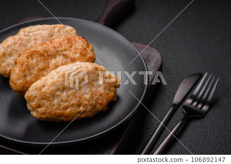 Delicious juicy cutlets or meatballs from minced chicken with salt and spices 106892147