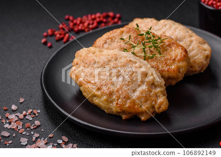 Delicious juicy cutlets or meatballs from minced chicken with salt and spices 106892149