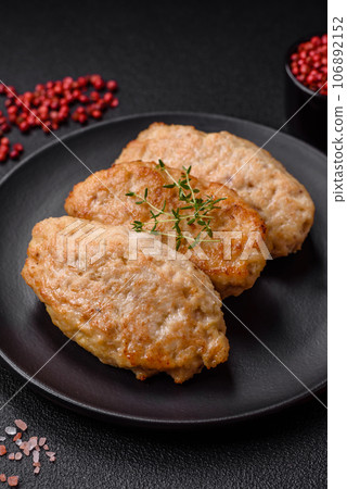 Delicious juicy cutlets or meatballs from minced chicken with salt and spices 106892152