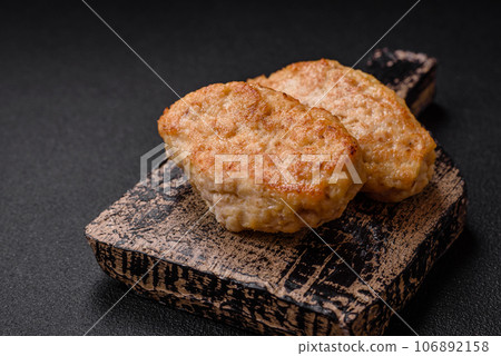 Delicious juicy cutlets or meatballs from minced chicken with salt and spices Delicious juicy cutlets or meatballs from minced chicken with salt and spices 106892158