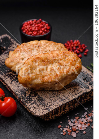Delicious juicy cutlets or meatballs from minced chicken with salt and spices 106892164