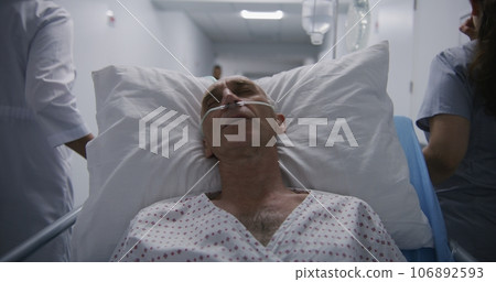 Patient with breathing tube tries to sleep on gurney after operation 106892593
