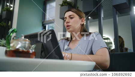 Female doctor consults patient via video call in hospital canteen 106892692