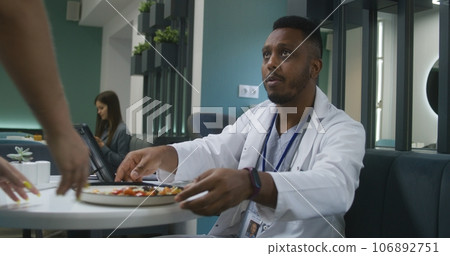 Medic uses digital tablet computer, examines tests results 106892751