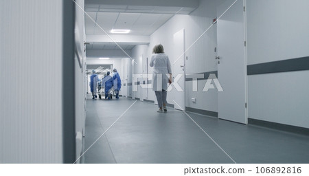 Doctors push stretcher with injured patient Doctors push stretcher with injured patient 106892816