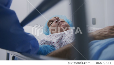 Doctor examines seriously ill aged man in clinic Doctor examines seriously ill aged man in clinic 106892844