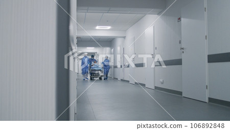 Doctors run and push gurney with injured patient Doctors run and push gurney with injured patient 106892848