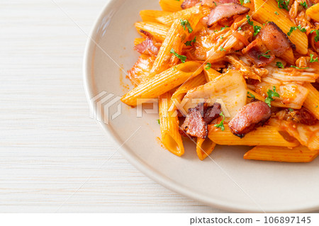 stir-fried penne pasta with kimchi and bacon 106897145