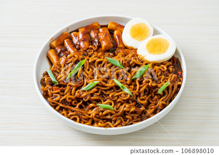 Jjajang Rabokki - Korean instant noodles or Ramyeon with Korean rice cake or Tteokbokki and egg in black bean sauce Jjajang Rabokki - Korean instant noodles or Ramyeon with Korean rice cake or Tteokbokki and egg in black bean sauce 106898010