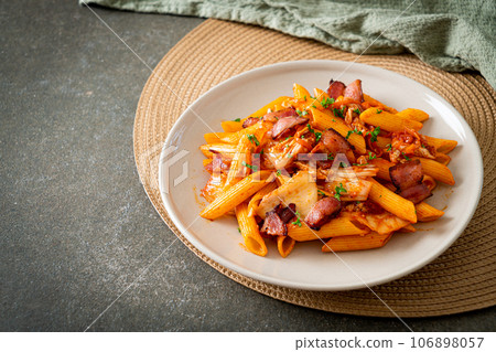 stir-fried penne pasta with kimchi and bacon stir-fried penne pasta with kimchi and bacon 106898057