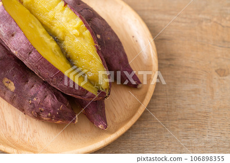 Grilled or baked Japanese sweet potatoes on wood plate Grilled or baked Japanese sweet potatoes on wood plate 106898355