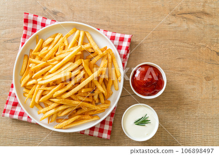 French fries with sour cream and ketchup 106898497