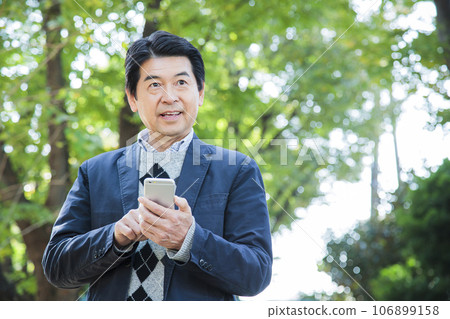 Middle-aged man walking in the park Middle-aged man walking in the park 106899158