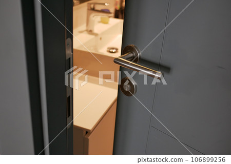 gray bathroom door slightly open . gray bathroom door slightly open . 106899256