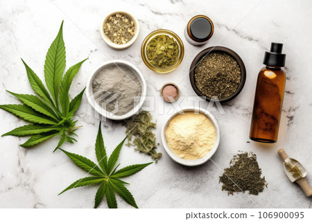 A top view of a collection of cannabis essentials arranged on a white stone table. Ideal for promoting natural remedies from above white background A top view of a collection of cannabis essentials arranged on a white stone table. Ideal for promoting natural remedies from above white background 106900095