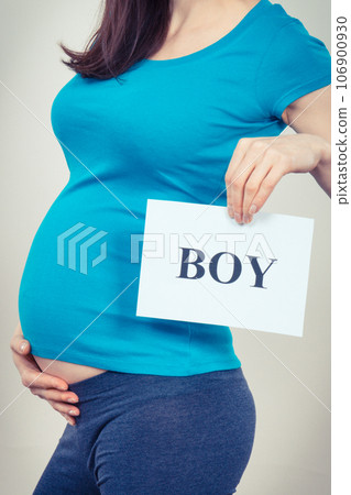 Pregnant woman holding card with inscription boy. Expecting for newborn. Extending family Pregnant woman holding card with inscription boy. Expecting for newborn. Extending family 106900930