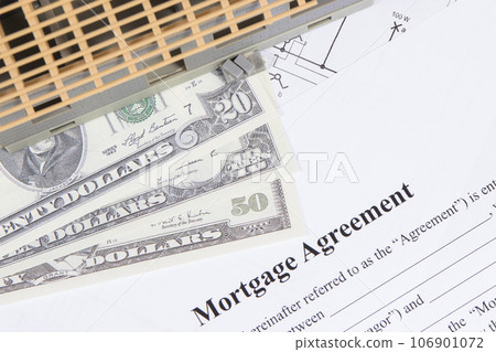 Small house under construction, mortgage agreement form and dollars 106901072