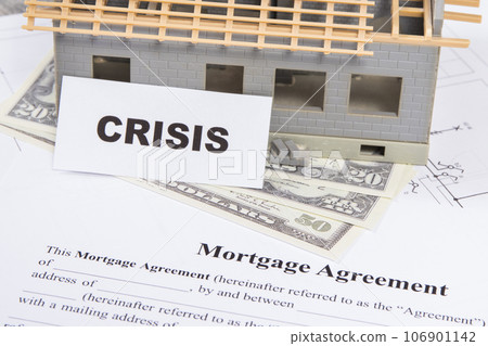 House under construction, mortgage agreement form, dollars and inscription crisis 106901142