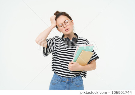 Portrait of young tired student, girl has headache, touching head with troubled face expression, sighing from complicated situation, standing over white background Portrait of young tired student, girl has headache, touching head with troubled face expression, sighing from complicated situation, standing over white background 106901744
