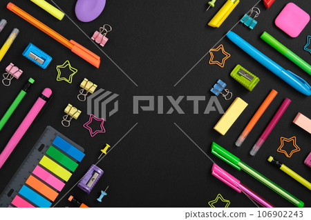 Knolling sationery background with colorful rainbow school and office stationery set on black background. Space for your text 106902243