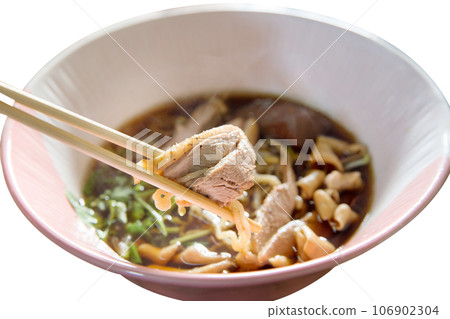 Top view of Duck noodle on a pink bowl with chopsticks on white isolated, focus selective 106902304