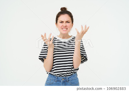 Portrait of angry woman shouting and shaking hands, losing her temper, arguing, standing over white background Portrait of angry woman shouting and shaking hands, losing her temper, arguing, standing over white background 106902883