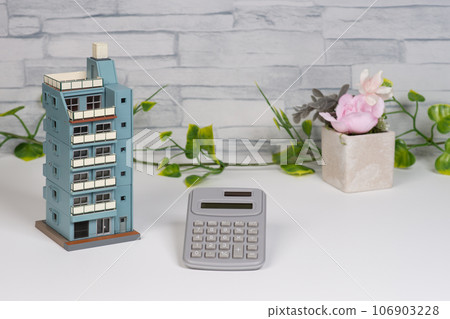 Image of real estate sale with condominium and calculator 106903228