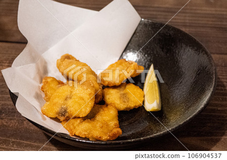 Fried blowfish served on a black plate Fried blowfish served on a black plate 106904537