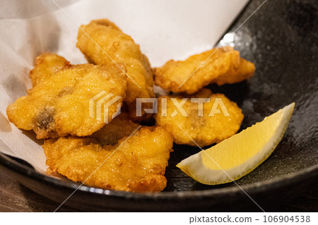 Fried blowfish served on a black plate Fried blowfish served on a black plate 106904538