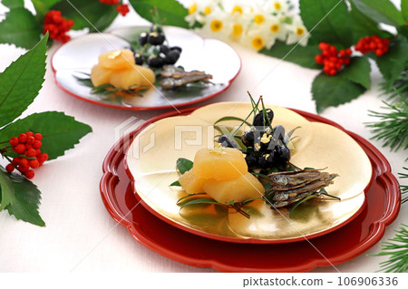 Three types of celebratory appetizers served on a gold and silver plum plate. Three types of celebratory appetizers. Osechi cuisine. Three types of celebratory appetizers served on a gold and silver plum plate. Three types of celebratory appetizers. Osechi cuisine. 106906336