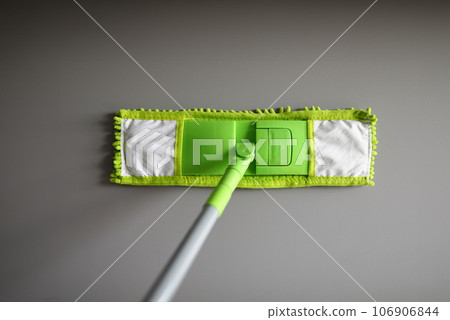 Plastic mop with green microfiber cloth closeup Plastic mop with green microfiber cloth closeup 106906844