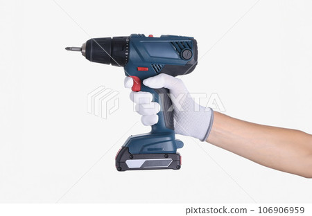 Master in glove holds a drill with drill on white background 106906959