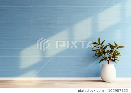 plant against a blue wall background with copy space 106907363