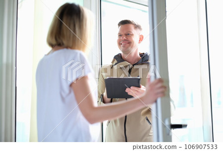 Smiling man conducting social survey in apartment 106907533