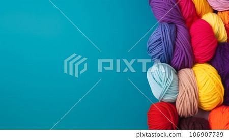 Knitting background with rainbow colorful yarn over blue background with copy space, neural network generated picture 106907789