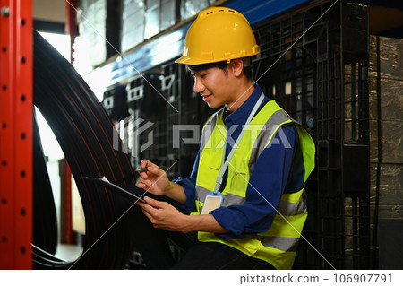 Photo of male worker inspecting, counting products stock in a warehouse for inventory management work Photo of male worker inspecting, counting products stock in a warehouse for inventory management work 106907791