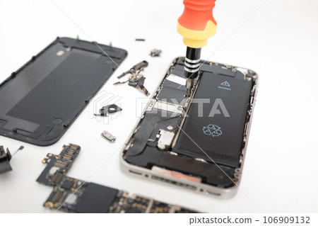 Technician repairing inside the smartphone motherboard with tools for recovery, The man repair by tightening nut from mobile phone with a screwdriver to fix problem Technician repairing inside the smartphone motherboard with tools for recovery, The man repair by tightening nut from mobile phone with a screwdriver to fix problem 106909132