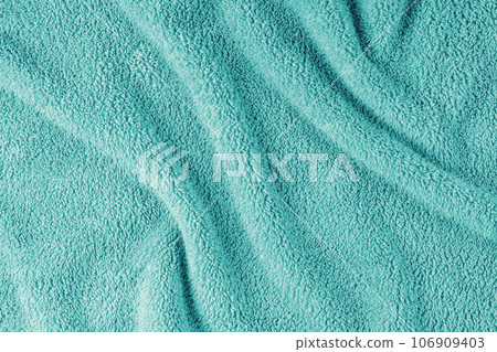 Terry cloth, turquoise towel texture background. Soft fluffy textile bath or beach towel material Terry cloth, turquoise towel texture background. Soft fluffy textile bath or beach towel material 106909403