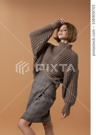 beautiful blonde woman in brown knitted sweater beautiful blonde woman in brown knitted sweater 106909705