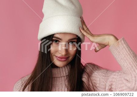 puzzled brunette woman feels sorry on pink background. 106909722