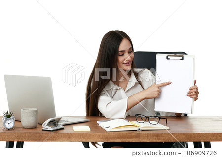 businesswoman in formal wear showing empty clipboard 106909726