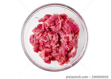 Top view of glass bowl with chopped pork tenderloin isolated on white background Top view of glass bowl with chopped pork tenderloin isolated on white background 106909930