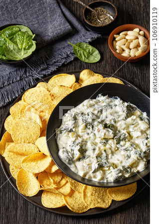 artichoke spinach almond dip with potato chips 106910119